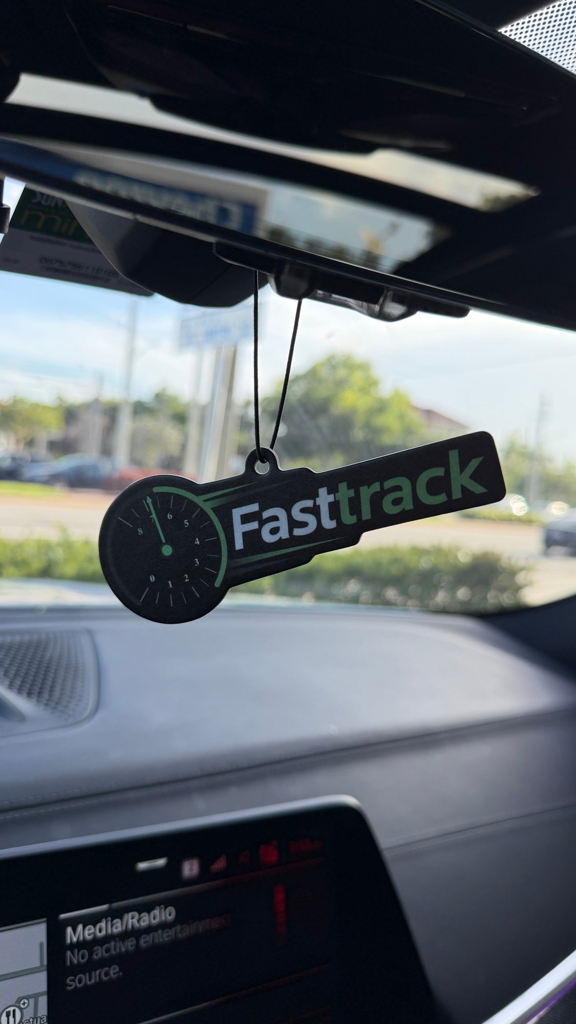 FastTrack air freshener hanging from a car rearview mirror